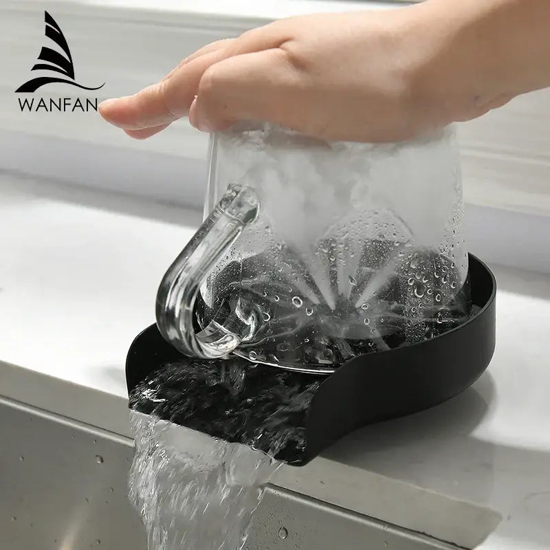 Black plastic automatic glass rinser and cup washer with water flowing and a clear mug on top for home kitchen sink