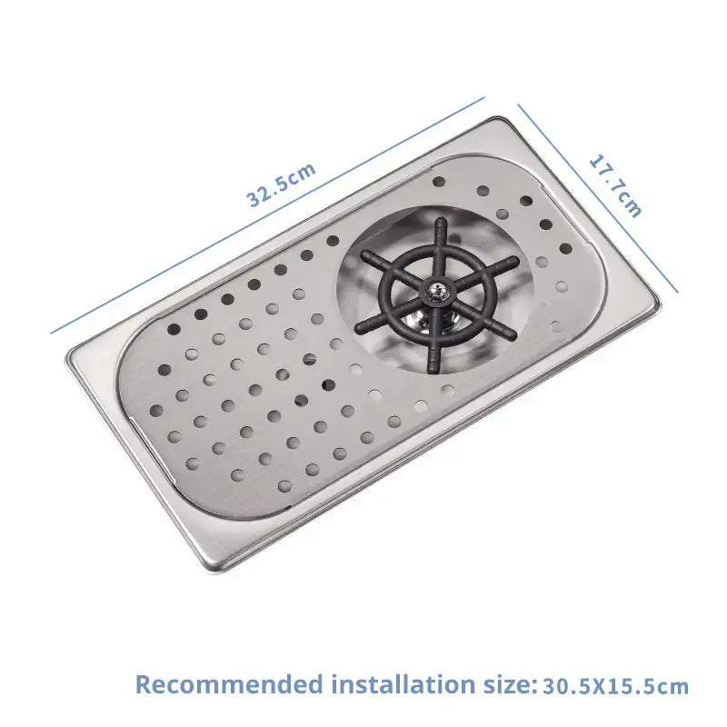 Rectangular stainless steel bar sink with black ship wheel drain cover and perforated surface for glass rinser faucet use