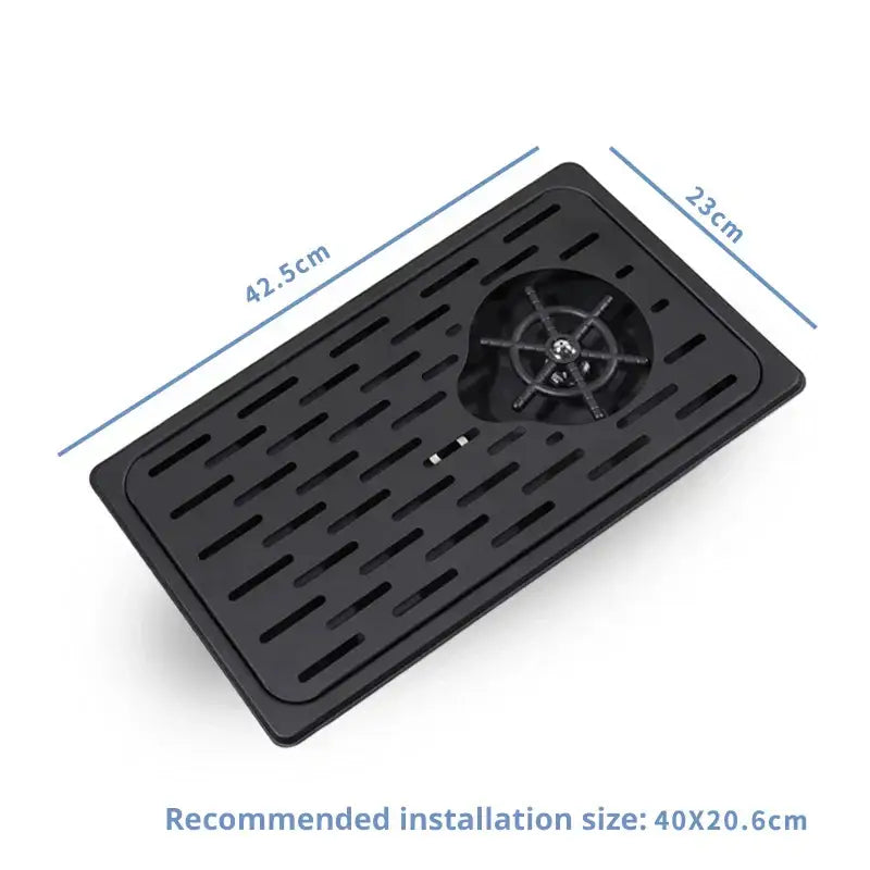 Black rectangular plastic glass rinser faucet tray with central circular filter and slotted drainage channels for kitchen use