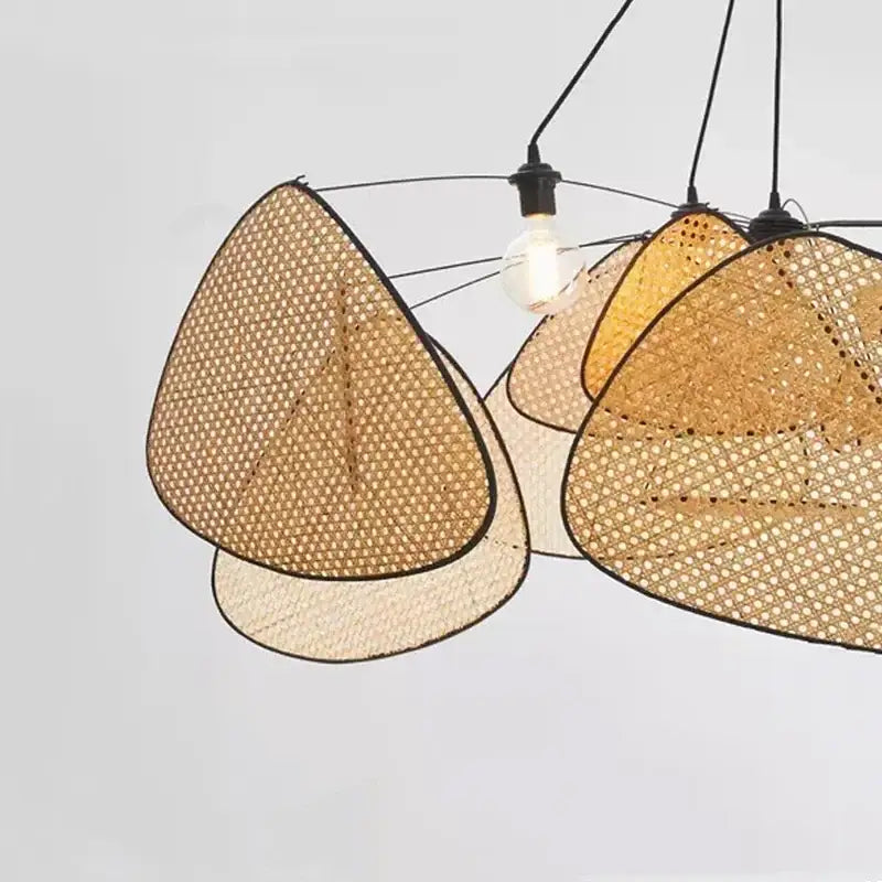 A black rattan ceiling chandelier with triangular woven rattan shades in natural beige and warm amber tones