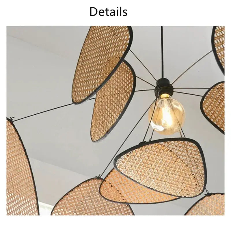 Black rattan ceiling chandelier with warm-toned woven rattan and black-framed leaf-shaped shades by decorbites