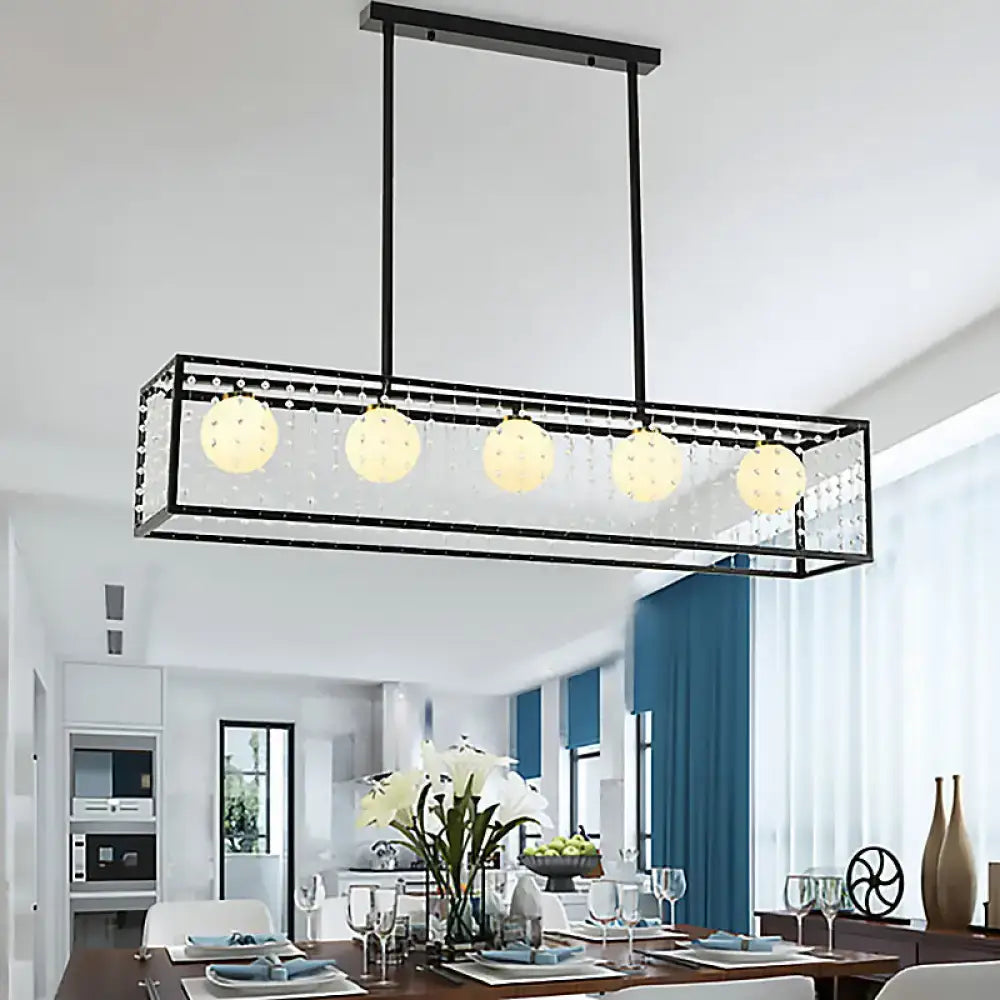 Black metal rectangle island pendant light kit with five opal glass globes and crystal accents for dining room use