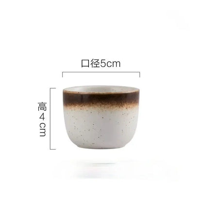 A ceramic wine sake cup with a speckled white body and brown rim from decorbites ceramic wine set for dining room use