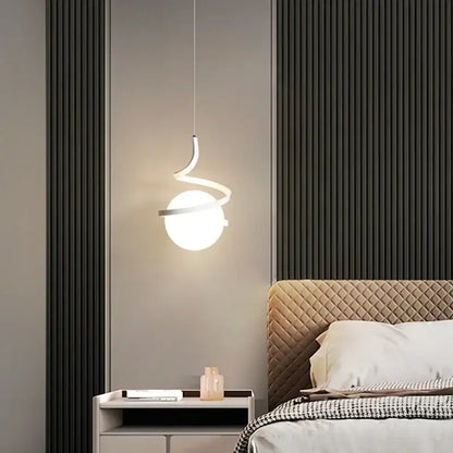 Modern minimalist black cord pendant light with a curved metallic frame and frosted glass globe for dining room installation