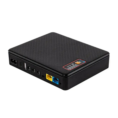 Black textured mini ups backup battery office router power supply with carbon fiber finish and multiple ports shown from back