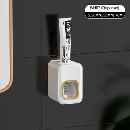 White toothpaste dispenser with gold trim holding colgate tube inside black translucent decorbites inverted toothbrush holder