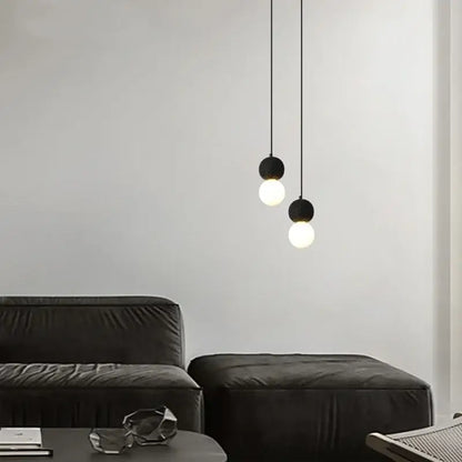 Black travertine led pendant light with spherical frosted glass bulbs hanging from thin cords for dining room decorbites black travertine