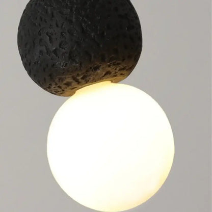 Black travertine led pendant light featuring a warm glowing white spherical bulb and lava stone design for dining room decorbites black travertine