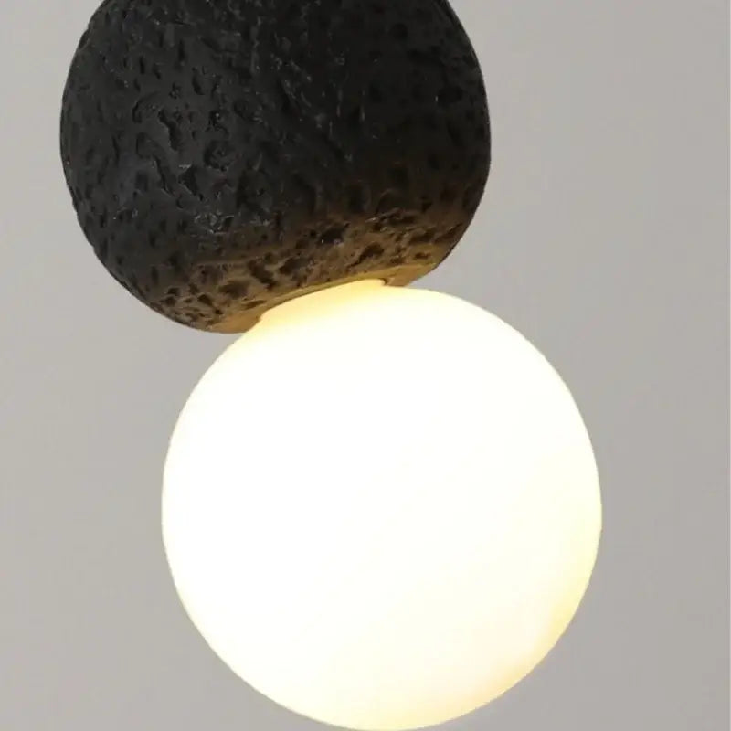 Black travertine led pendant light featuring a warm glowing white spherical bulb and lava stone design for dining room decorbites black travertine