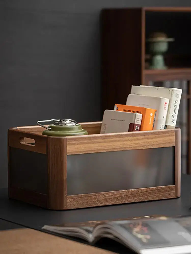A black walnut wood desktop organizer with a translucent glass front and integrated handles holding books and a teapot