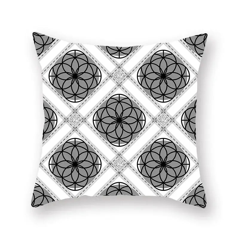 Square throw pillow featuring a black white and gold geometric star stripe print with intersecting circles and diamond shapes