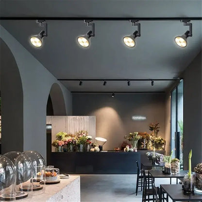 Black and white metallic decorbites cob ceiling spotlight with 4 adjustable led lights illuminating a modern floral shop interior