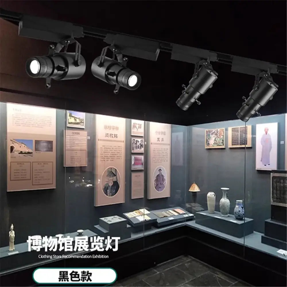 Black wireless remote led spotlight stage light with adjustable spotlights mounted above museum exhibit display