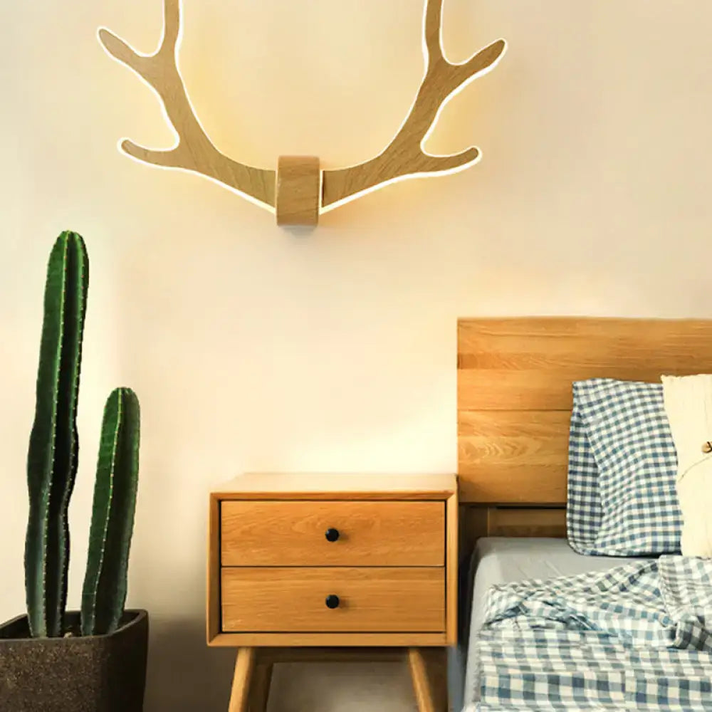 Black wooden antler wall lamp with warm led lighting designed as an elegant antler wall sconce for corridors