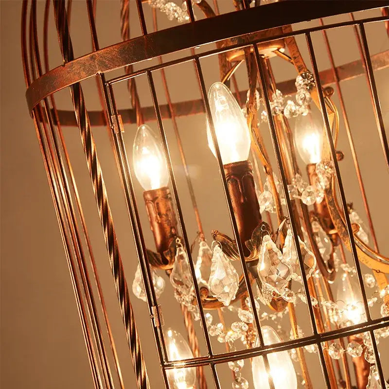 A warm-toned copper bird cage chandelier with twisted metal bars and crystal bird cage droplets for dining room decorbites crystal bird light