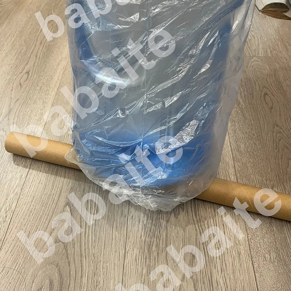 A blue plastic water jug wrapped in clear plastic featured with decorbites™ blonde ocean poster prints for home decor