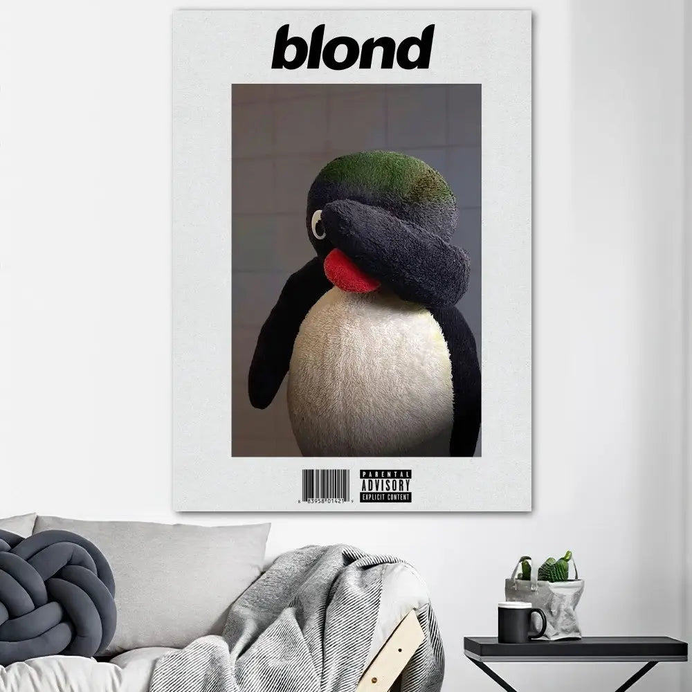 White framed poster print featuring plush black and white penguin with green tuft for home decor oceans poster prints