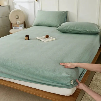 A soft mint green fitted sheet with subtle textured weave and neatly finished edges from decorbites coarse cotton queen collection