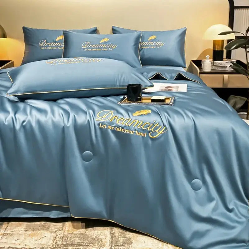 Blue satin quilt set with gold embroidered feather and dreamcity design made of ice silk summer fabric