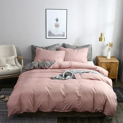 Pink cotton duvet cover set with matching pillows and gray accent pillow in a blue and gray grain pattern bedding set