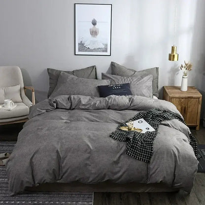 Blue and gray grain pattern duvet cover set with gray textured duvet and black and white checkered throw blanket on bed