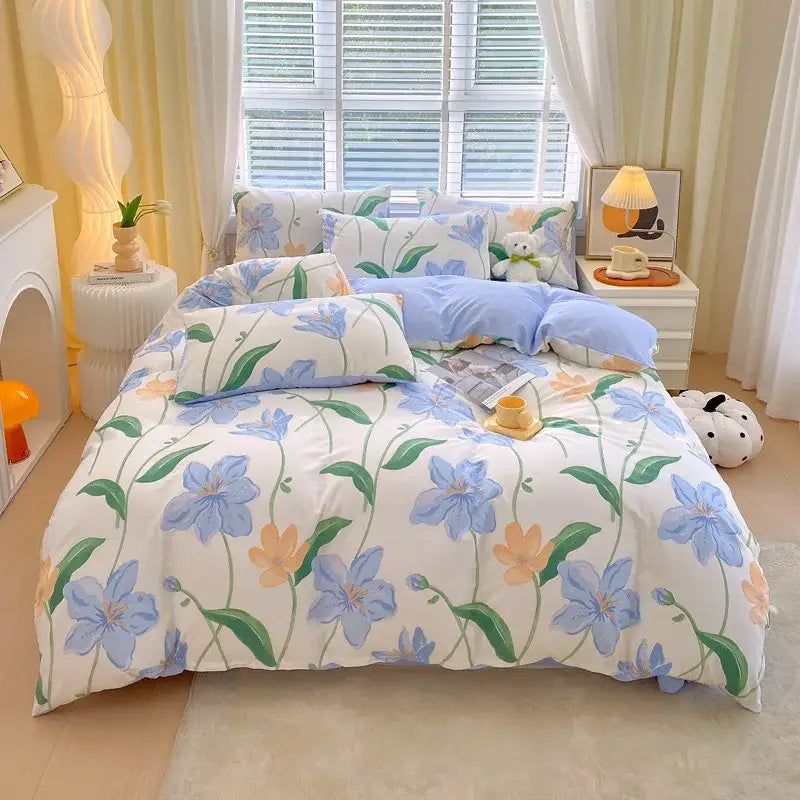 A soft white decorbites cotton single duvet cover with blue and peach floral vines and matching pillowcases