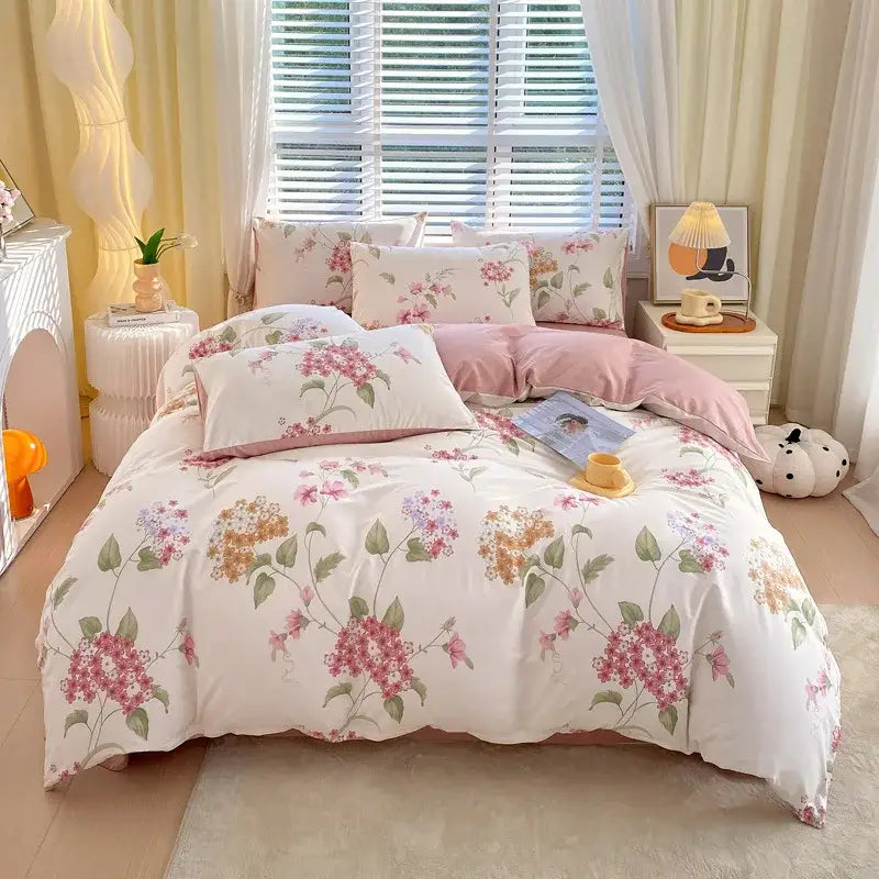 Floral-patterned decorbites cotton single duvet cover with soft pink and green blossoms on creamy white base with matching pillows