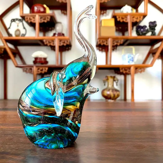 Translucent crystal glass elephant sculpture with swirling blue green and gold patterns for living room decor