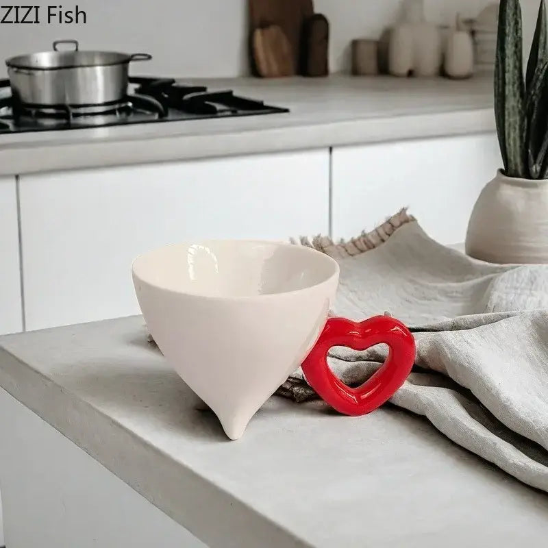 Cream-colored heart shape ceramic bowl with glossy finish and vibrant red decorbites heart shape handle for fruit juice