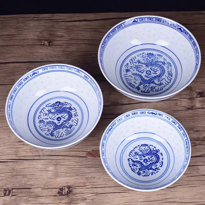Three white ceramic ramen bowls with intricate blue dragon pattern and decorative borders for dining room use