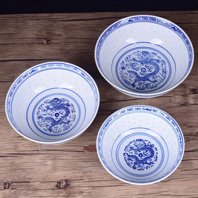 Three white ceramic ramen bowls with intricate blue dragon pattern and decorative borders for dining room use
