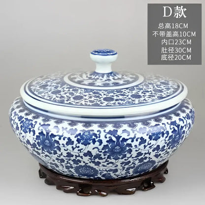 Blue and white floral ceramic tea caddy jar with intricate patterns and matching lid on ornate wooden base for decor