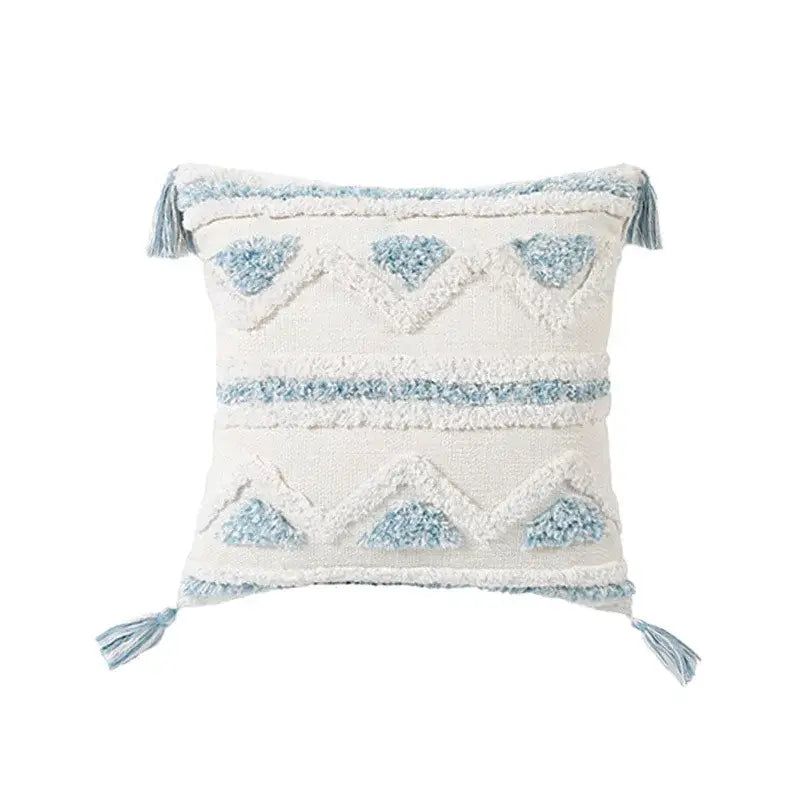 Cream-colored throw pillow with light blue geometric embroidery and tassels from decorbites blue geometric pillowcase set