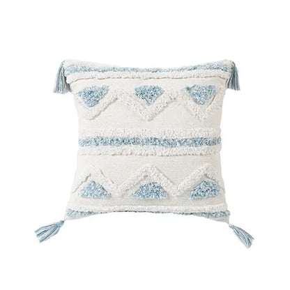 Cream-colored throw pillow with light blue geometric embroidery and tassels from decorbites blue geometric pillowcase set