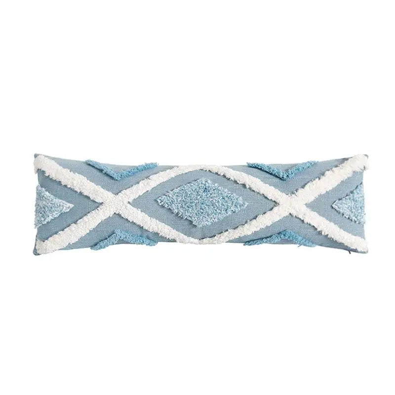 Light blue rectangular pillow from pillowcase set with white fringed geometric patterns and textured diamond accents