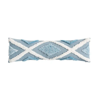 Light blue rectangular pillow from pillowcase set with white fringed geometric patterns and textured diamond accents