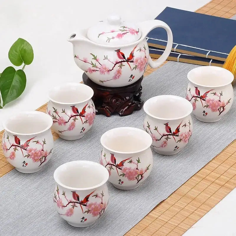 Blue and white double ceramic teaware set featuring white ceramic with pink cherry blossoms and red birds for dining room use