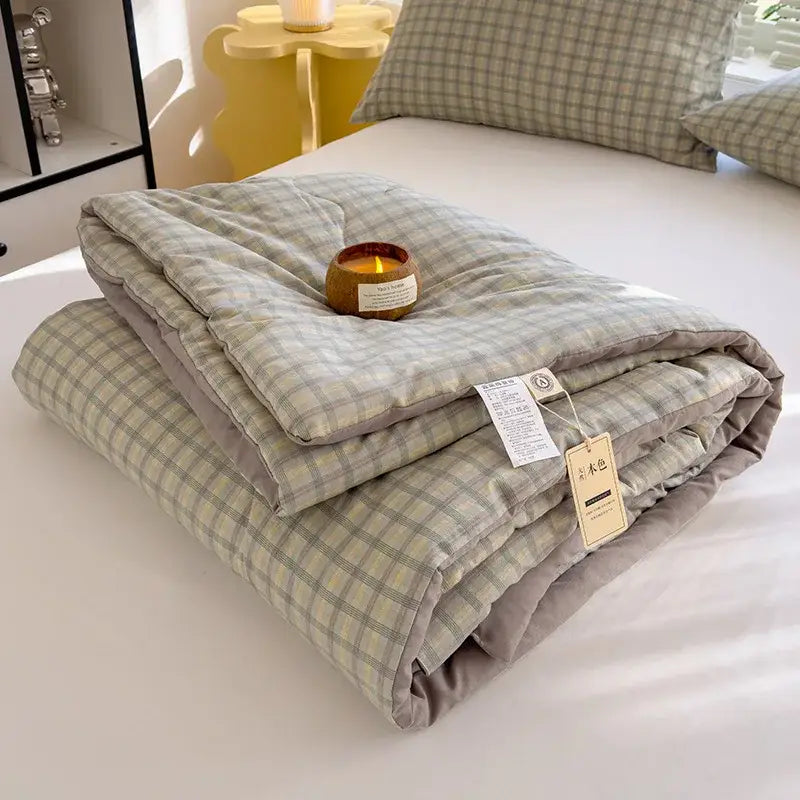 A soft cotton summer quilt in light gray and beige plaid with a solid gray border for bedroom comforter use