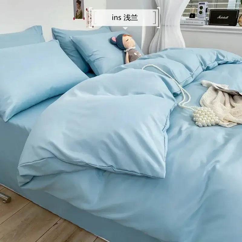 Light blue satin-like bedding set with soft plush texture and matching pillows for decorbites comfort king size bedroom