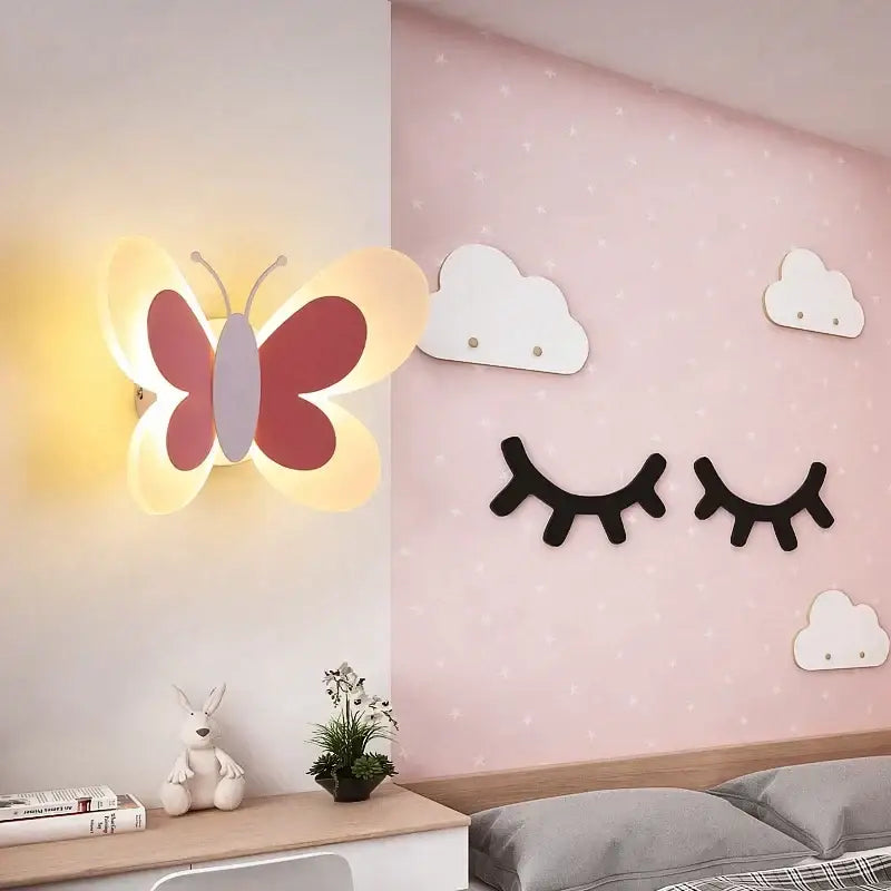A warm glowing butterfly girl cartoon wall light with red and white wings for a cartoon children room bedroom
