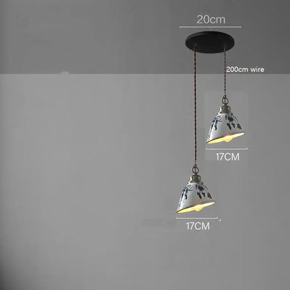 White ceramic led pendant lamp with black floral patterns and brass accents suspended by 200cm wire for dining decorbites ceramic led