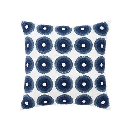White throw pillow with navy blue embroidered circular patterns in a decorbites blue floral geometric cushion cover set