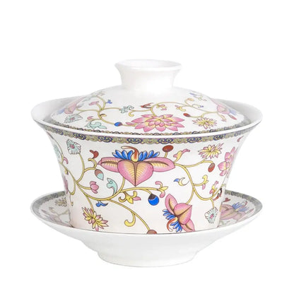 Blue floral white porcelain tea cup set featuring intricate pink blossoms gold vines on a delicate porcelain tea cup