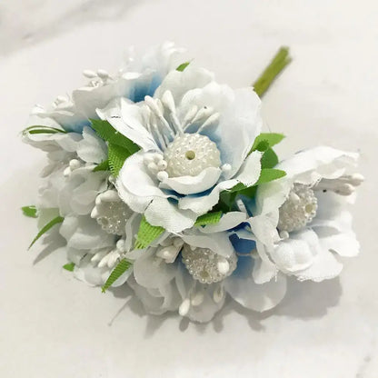 A delicate decorbites blue flower cherry stamen fabric bouquet with pearl embellishments and green satin leaves for decor