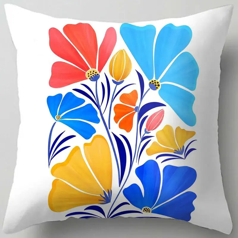 White throw pillow with vibrant blue flower leaves pattern and bold red blue yellow blossoms for decorbites blue flower decor