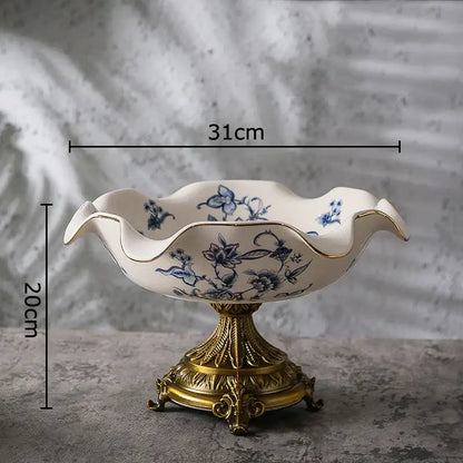 White ceramic fruit bowl with blue flower pattern footed on ornate gold metal base for dining room decorbites blue flower