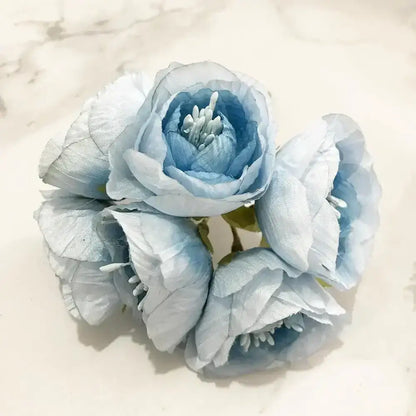 A delicate cluster of light blue fabric blue flower stamen berries with soft layered petals for kitchen cake decor
