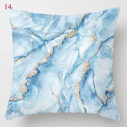 Blue geometric marble throw pillow with white and blue marble pattern and gold glitter accents for living room decor
