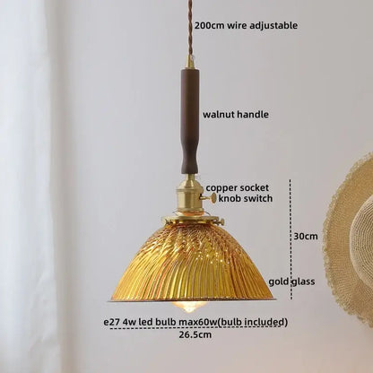 A warm golden pendant lamp with textured glass shade and walnut handle from decorbites blue glass led collection
