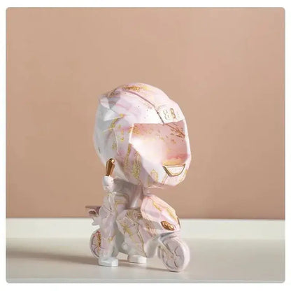 A pink and white geometric motorcycle figurine with gold accents featured in blue and gold marble helmet decorbites decorative key storage